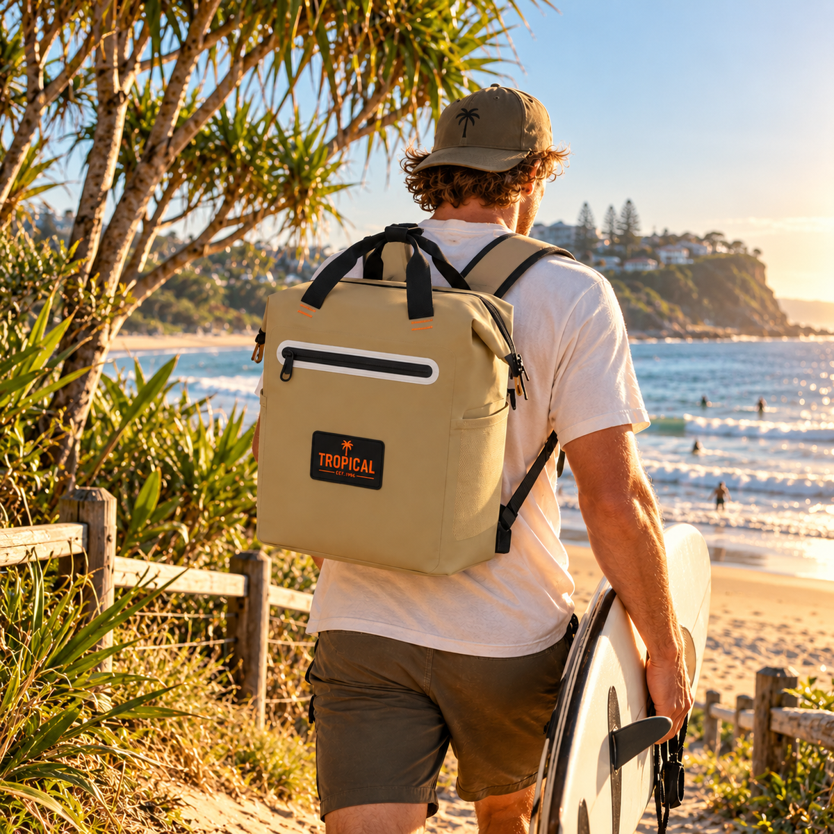 Tropical Backpack Cooler Bag in Sandman worn by a surfer heading down to an Australian beach